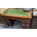 A late 20th century yew twin pedestal nine-drawer desk 79cm h x 122cm w Location: If there is no