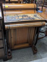 A Victorian inlaid ebony and walnut Davenport, with an arched top, over a hinged flap with a