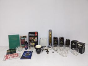 A collection of Guinness memorabilia to include half pint mugs, Silver Jubilee ale model, a boxed