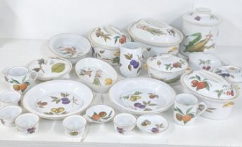 A collection of Royal Worcester Evesham pattern to include tureens, a biscuit jar, ramekins,