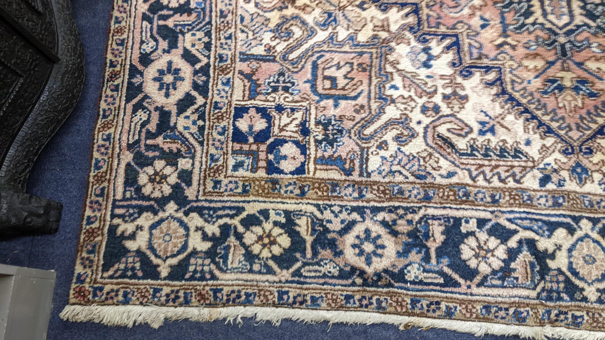 A Persian handwoven rug having a central motif and geometric designs 333cm x 250cm Location: If - Image 2 of 5