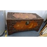 A mid 20th century Chinese camphor wood carved blanket chest inlaid with decorations of sailing