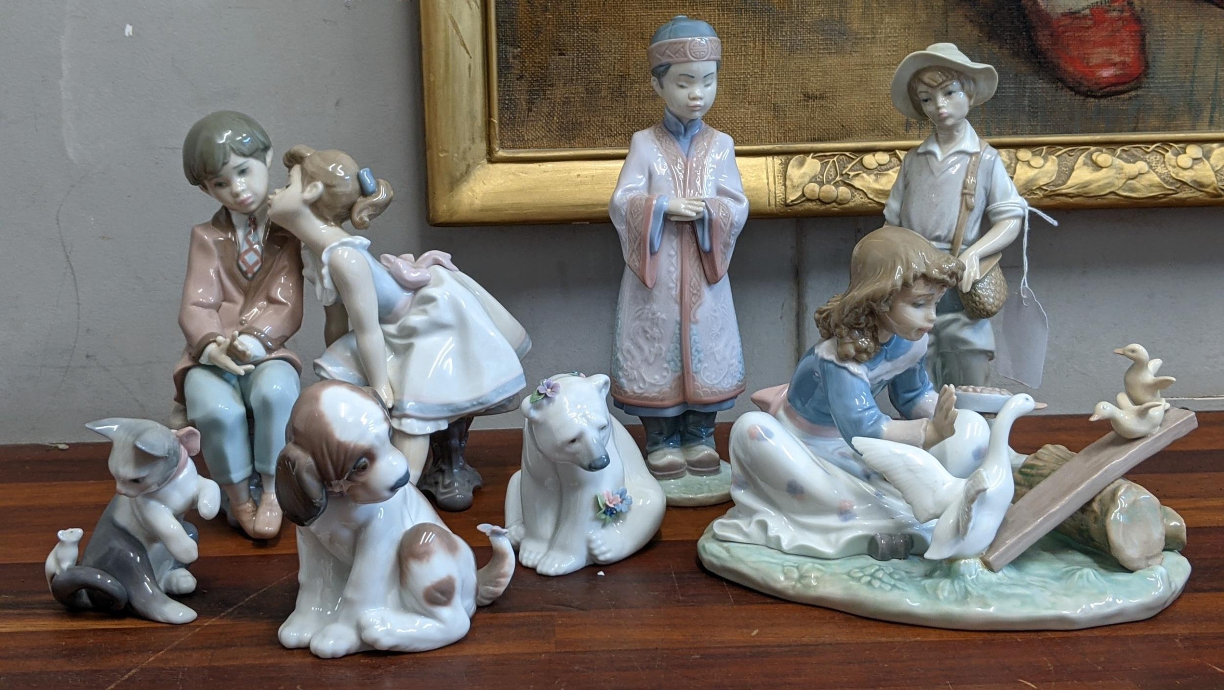 Seven Lladro figures to include a Kitten and Mouse, a Dog and Butterfly, a Polar Bear covered in