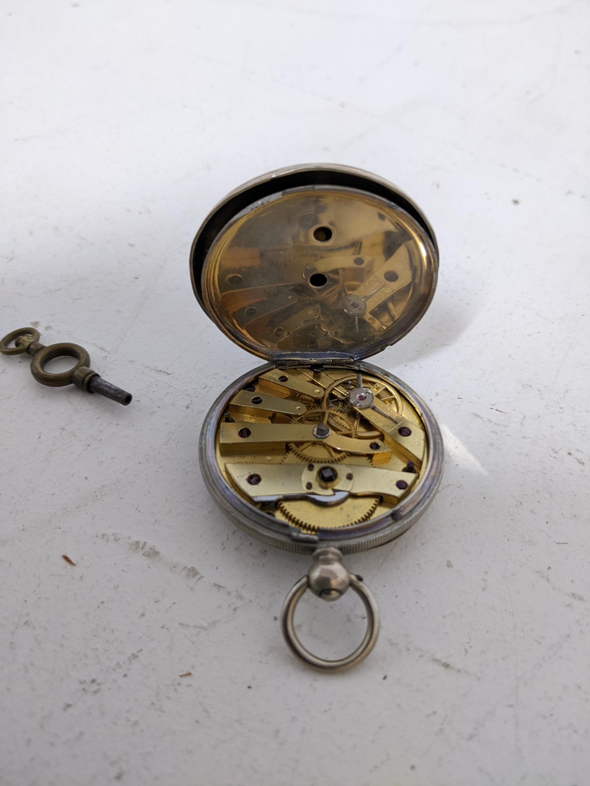 A Swiss white metal and key wound pocket watch, white enamel Roman dial marked Johnson Geneve, the - Image 3 of 4