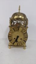 A brass eight day mantle clock in the style of a 17th century lantern clock by St James Location