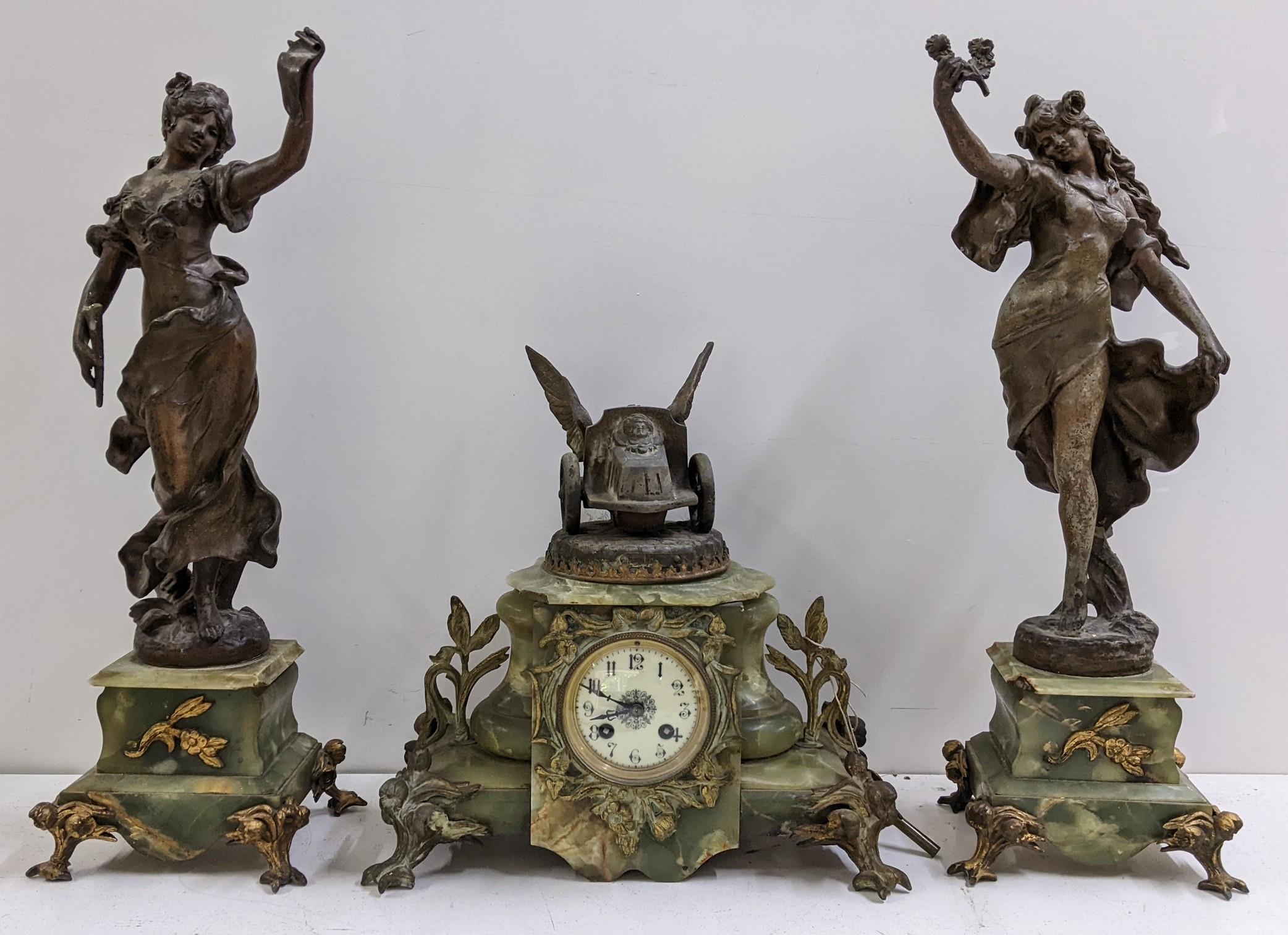 A late 19th century French onyx clock garniture set applied with gilt metal mounts and spelter