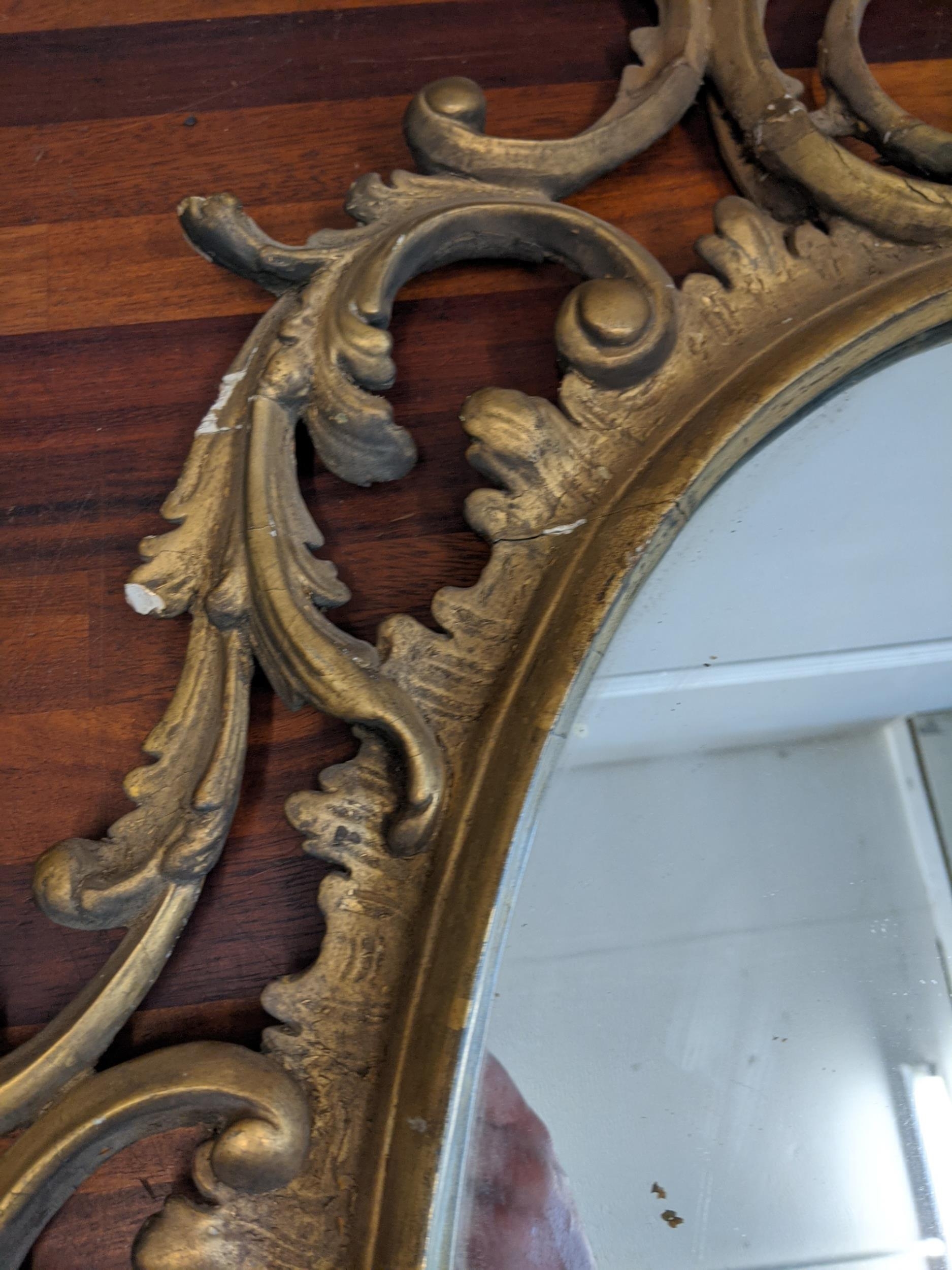 A late 19th /early 20th century oval gilt wall mirror ornately and symmetrically decorated in - Image 4 of 9