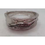 An American silver bangle with lizard decoration stamped 925, makers mark EA, having inset