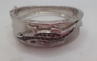 An American silver bangle with lizard decoration stamped 925, makers mark EA, having inset