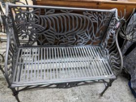 A grey painted iron two-seater garden bench with three wrought garden chairs, and a pair of pedestal