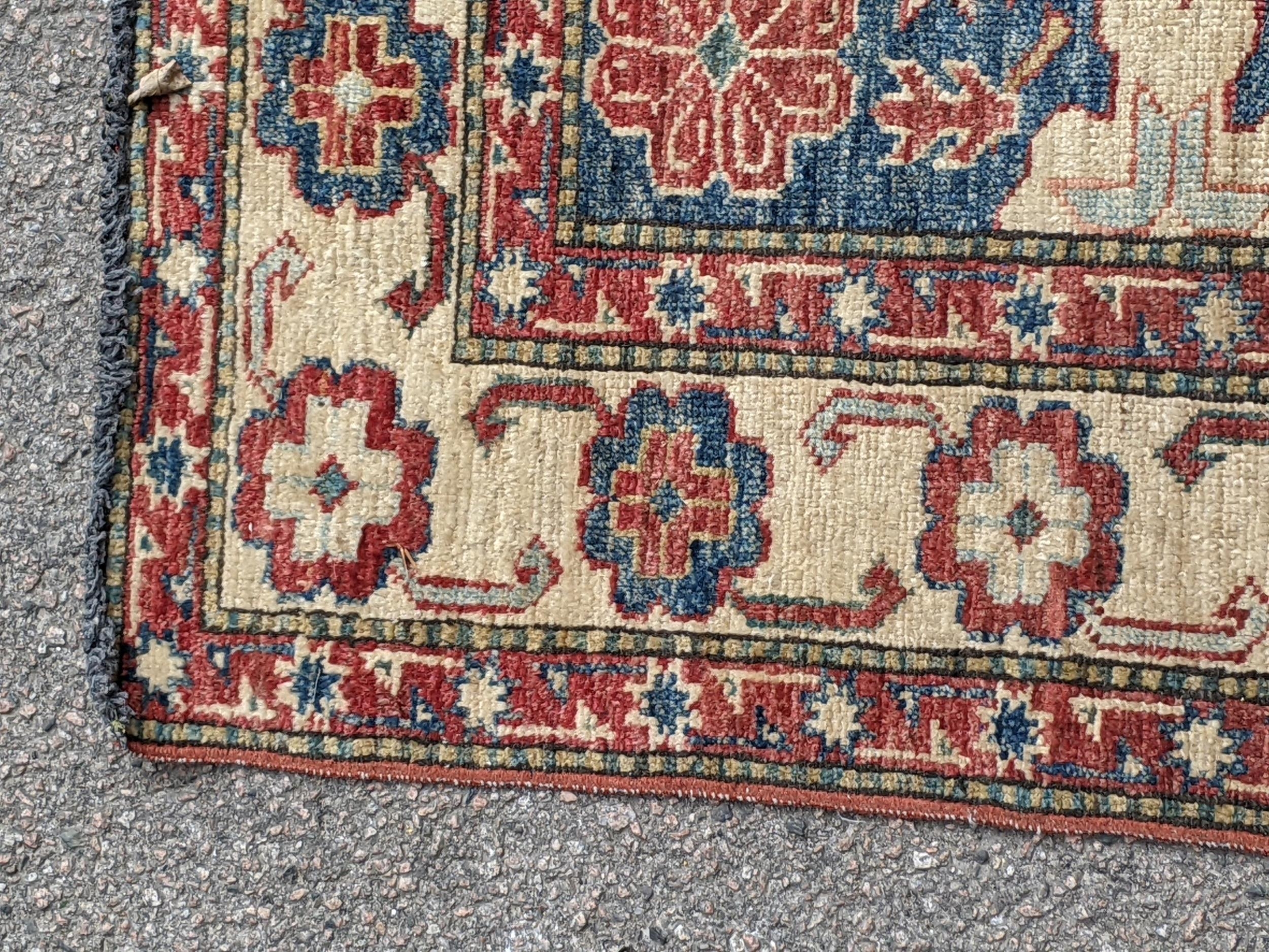 A Persian bidjar with a central emblem decorated symmetrically on a blue background with a cream and - Image 4 of 7