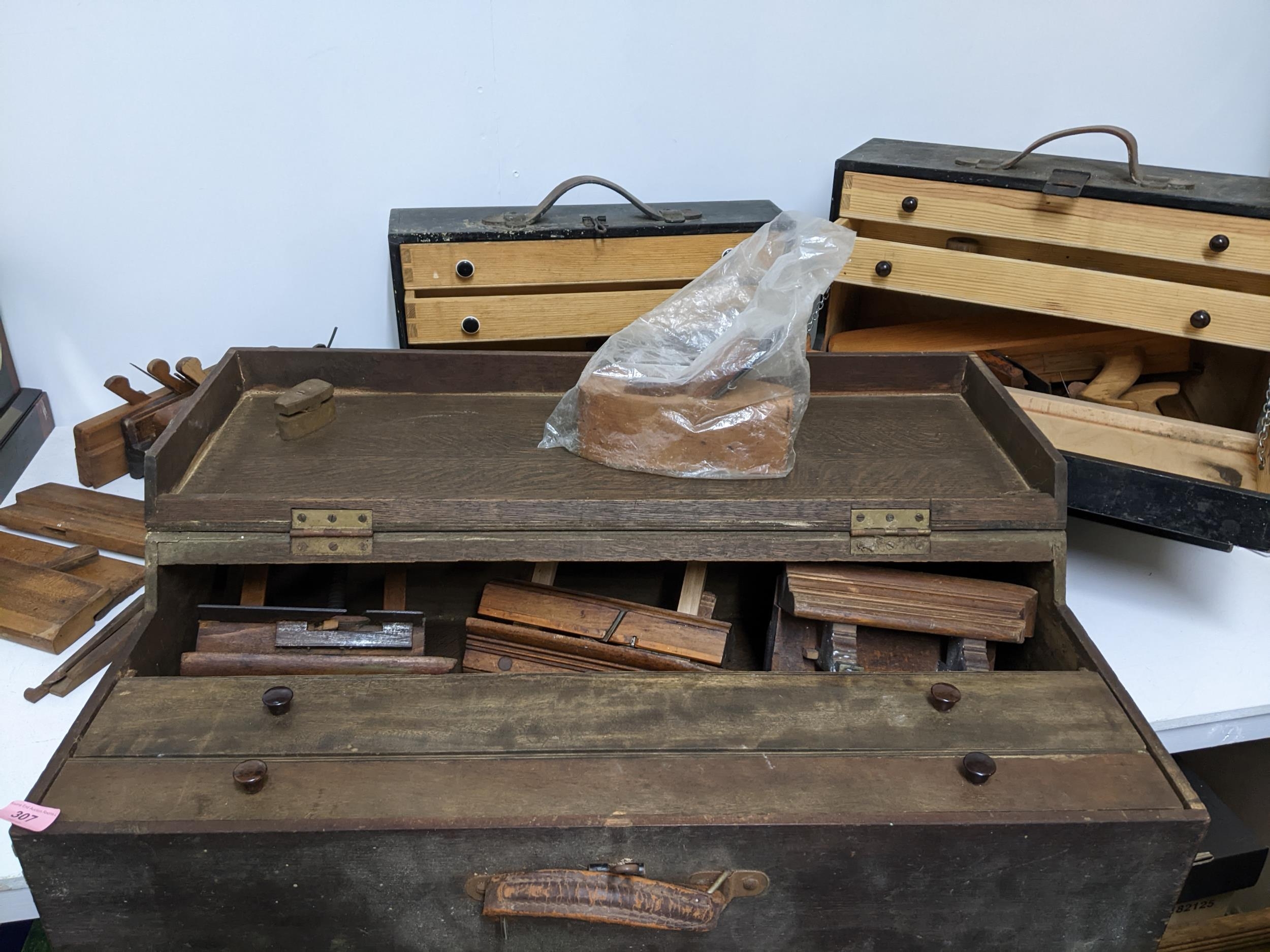 Three early 20th century wooden tool boxes containing various wood working planes and other moulding