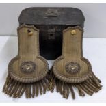 A cased pair of early 20th century Royal Navy Reserve officers dress epaulettes, the tin case