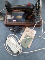 A 1929 99k Singer electric sewing machine A/F, serial number Y695604 having a domed case and oak