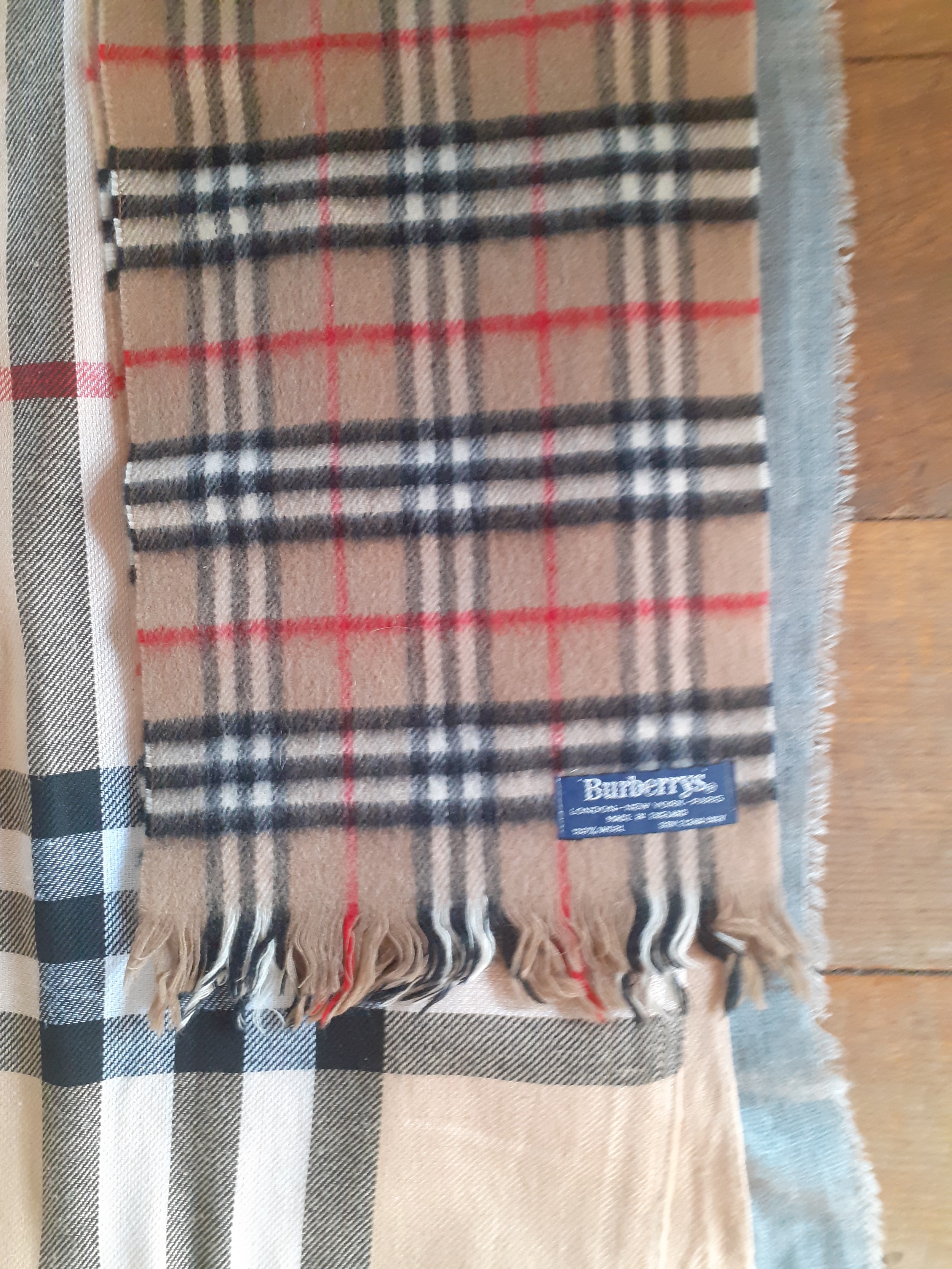 Four wraps and 1 scarf in a tartan design, 2 in the style of a British fashion designer Location:RAF - Image 3 of 4