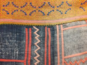 A hand woven tribal blanket/throw/wall covering having sections of yellow, blue, pink and orange