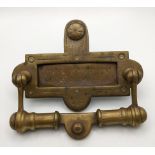 A Victorian brass letter rack with an integrated door knocker Location: If there is no condition