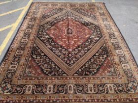 A north Tabris machine made carpet decorated with a central medallion, surrounded by floral