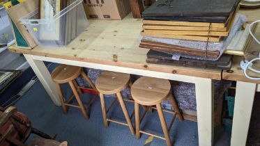 A modern pine kitchen table on painted block shaped legs 80h x 180w Location: RAF If there is no