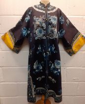 An early/mid 20th Century Chinese navy silk overcoat embroidered with satin stitches and Chinese