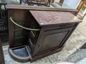 A Victorian oak hall side cabinet with pink variegated marble top flanked by brass sectioned stick