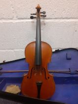 A reproduction Antonius Stradivarius violin with bow and accessories in a fitted case, back length