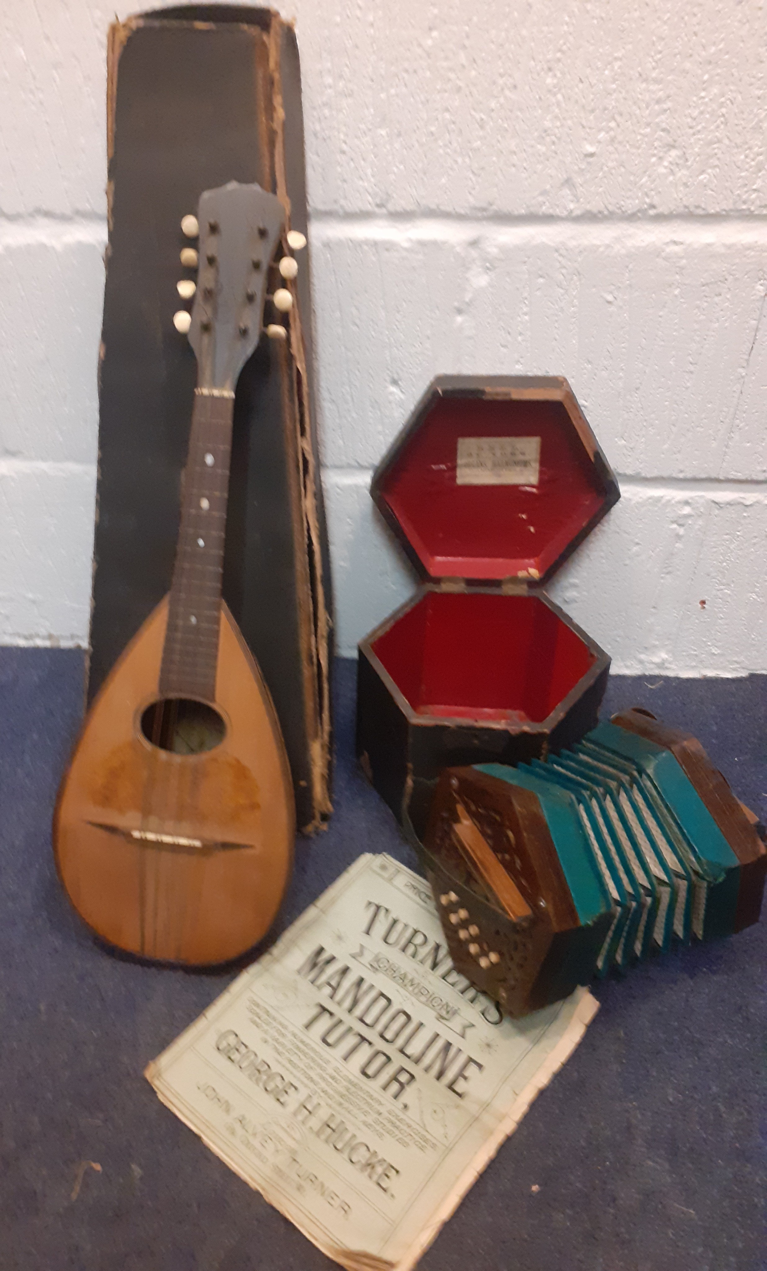 Two vintage musical instruments comprising a Napoli mandolin with music sheets and case A/F and a