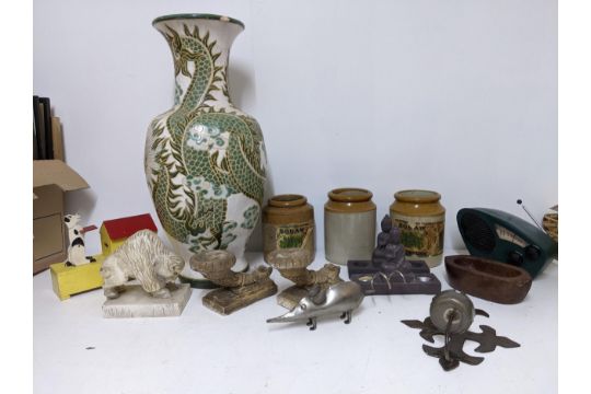 A mixed lot to include a carved alabaster model of a buffalo, painted wooden doghouse money bank,