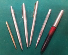 A group of pens and pencils to include 2 Parker ballpoint, a Parker propelling pencil, a silver