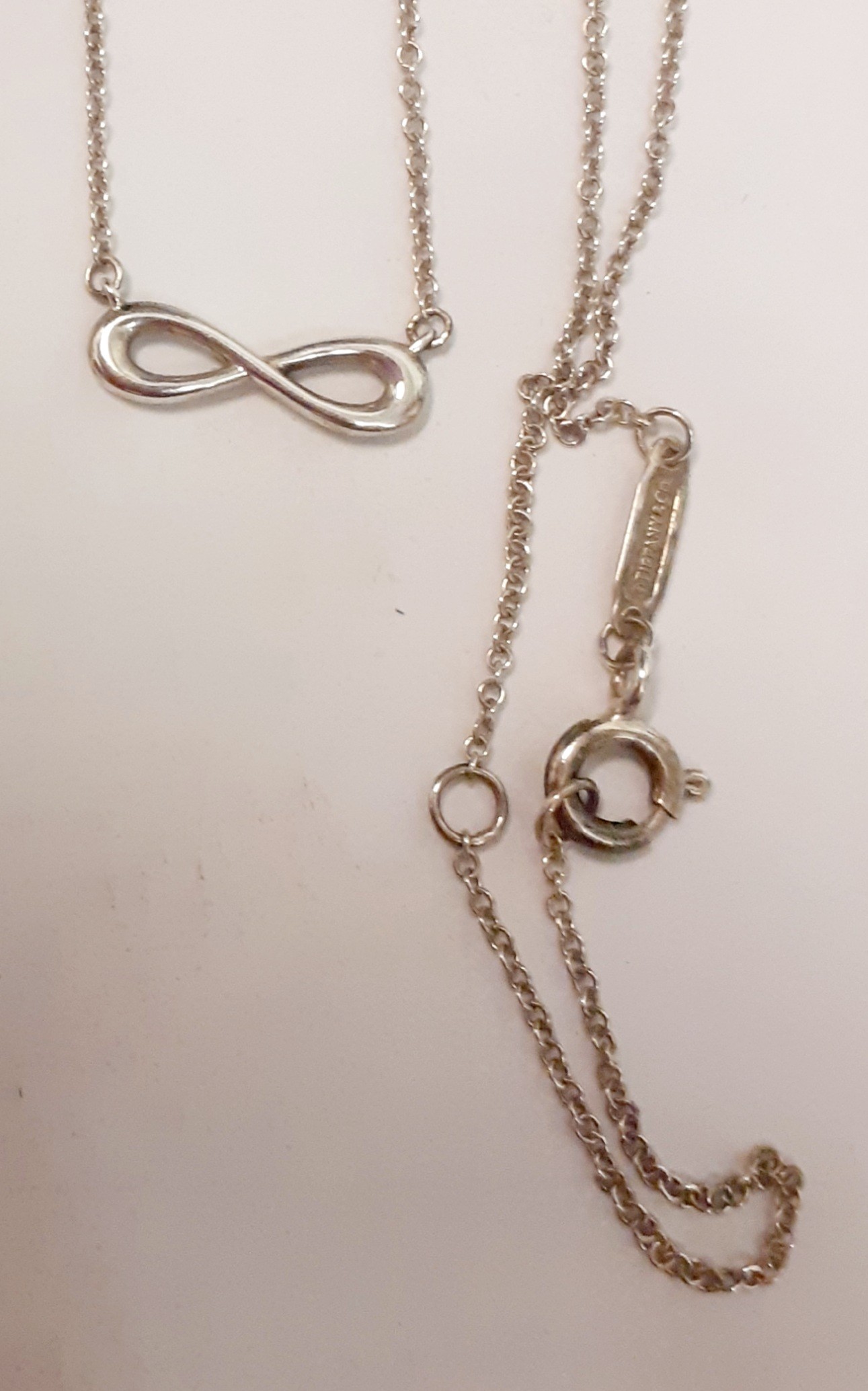 Tiffany & Co-A silver fine chain with infinity pendant, stamped 925, 1.55g together with a branded - Image 2 of 2