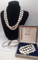 A freshwater coin pearl 2-string necklace and matching bracelet having silver clasps, an engraved