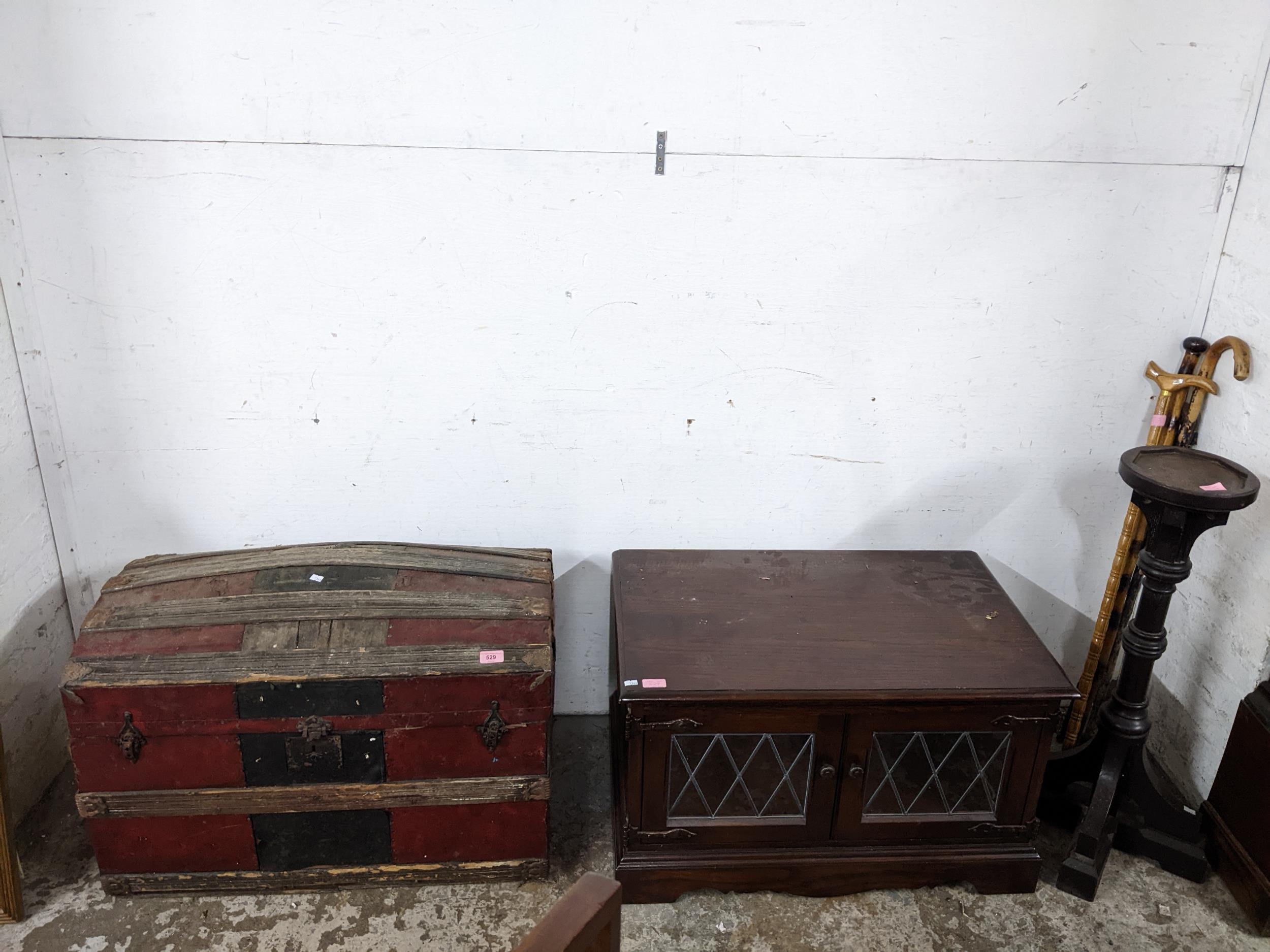 A mixed lot of furniture to include a partially leather clad wooden domed top trunk, an Old Charm TV