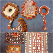 A selection of traditional Indian hand embroidered and hand sewn items to include embroidered head