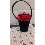 Lulu Guiness- A flower pot bag having fuchsia coloured fabric roses in a satin black pot design