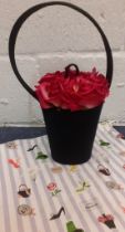 Lulu Guiness- A flower pot bag having fuchsia coloured fabric roses in a satin black pot design