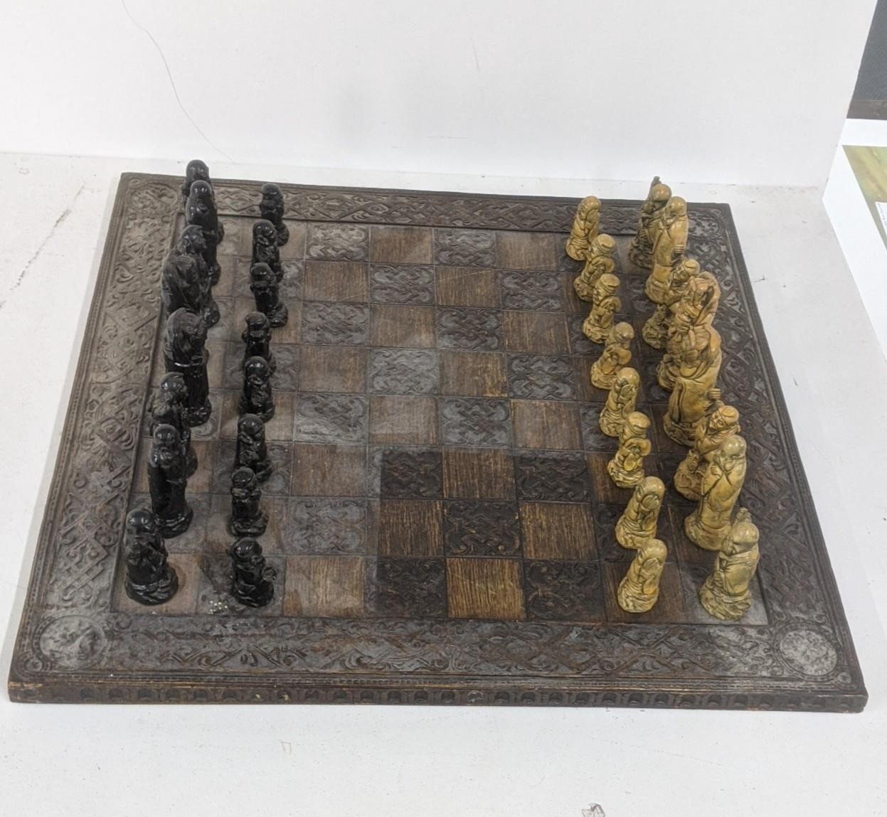 A mid/late 20th century Oriental wooden carved chessboard, 60.5cm x 60.5cm, together with resin cast