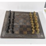 A mid/late 20th century Oriental wooden carved chessboard, 60.5cm x 60.5cm, together with resin cast