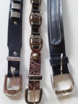 A group of 3 x 1980's belts to include a gold tone and brown snakeskin belt and a Levi black leather