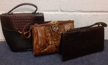 Two mid 20th Century crocodile bags and a later black leather and faux crocodile bag. Location: If