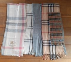 Four wraps and 1 scarf in a tartan design, 2 in the style of a British fashion designer Location:RAF