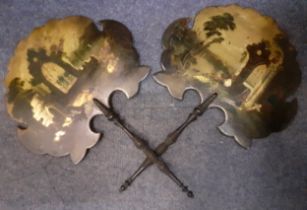 A pair of late 19th Century treen face fans having painted scenes of church ruins and figures