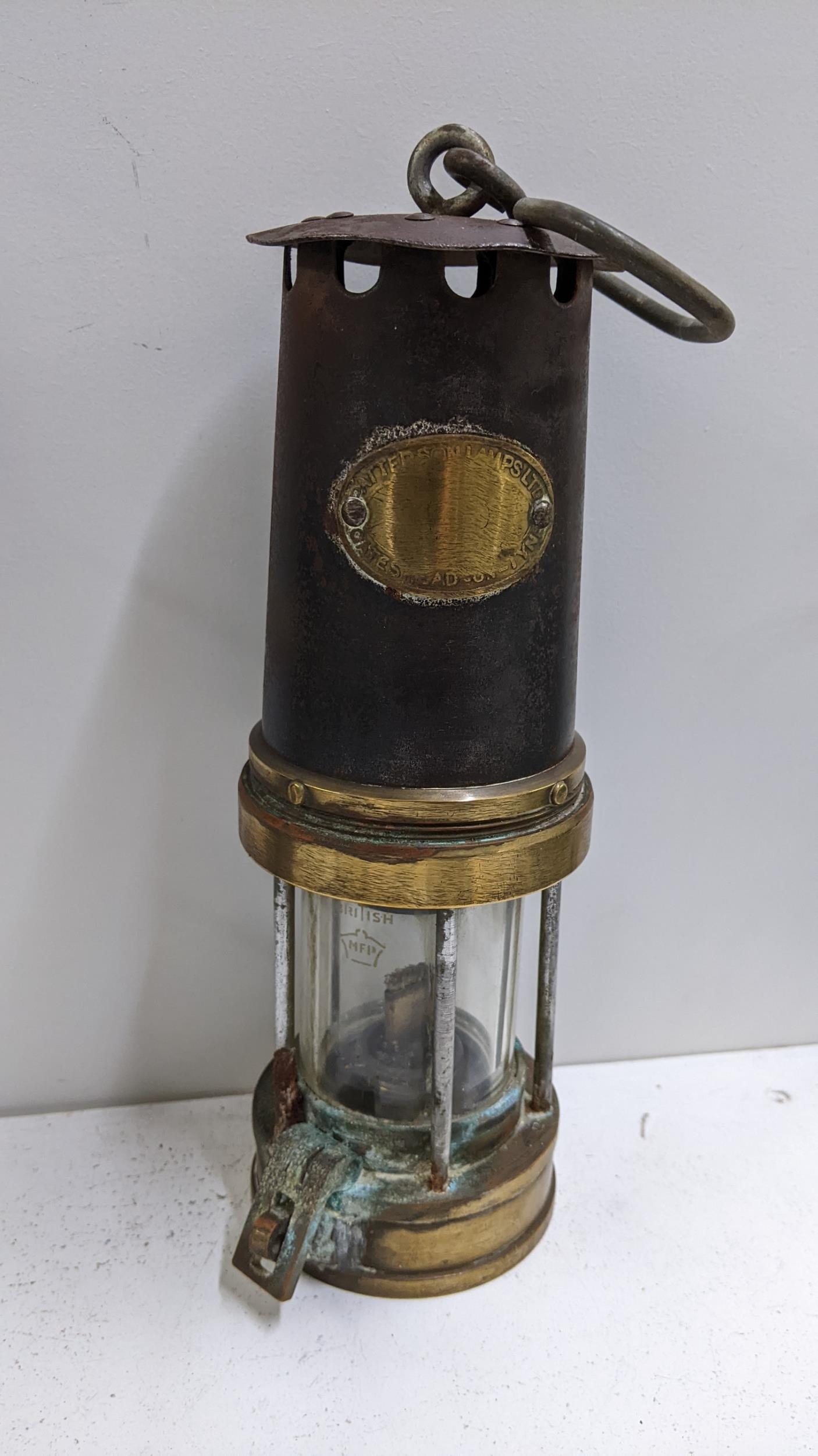 A brass and steel miners lamp by Patterson lamps Ltd Location: If there is no condition report