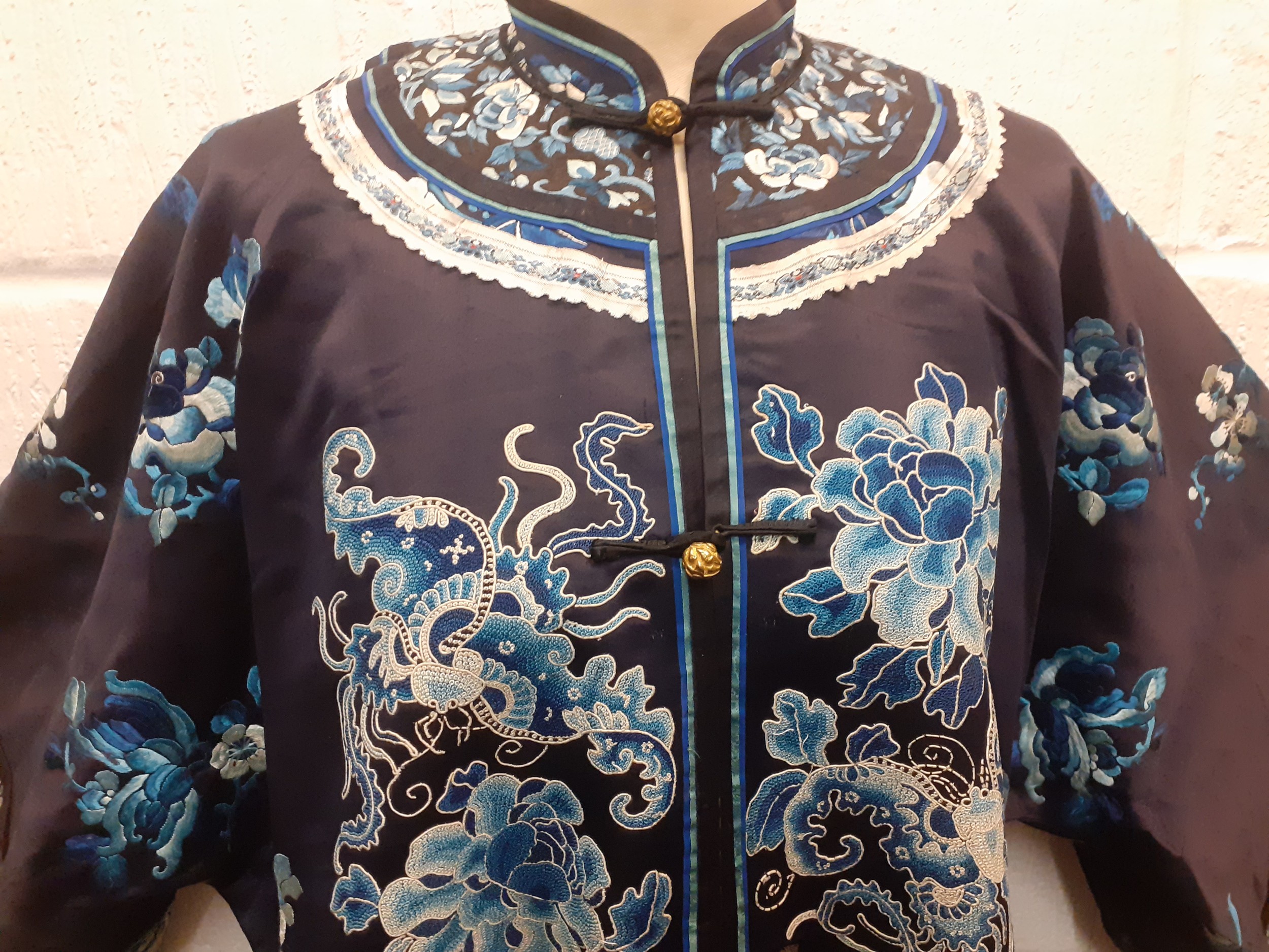An early/mid 20th Century Chinese navy silk overcoat embroidered with satin stitches and Chinese - Image 2 of 9