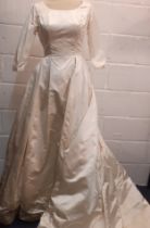 A 1961 cream silk wedding dress with ¾ sleeves, 28" waist x 36" chest, bow detail to rear waist with