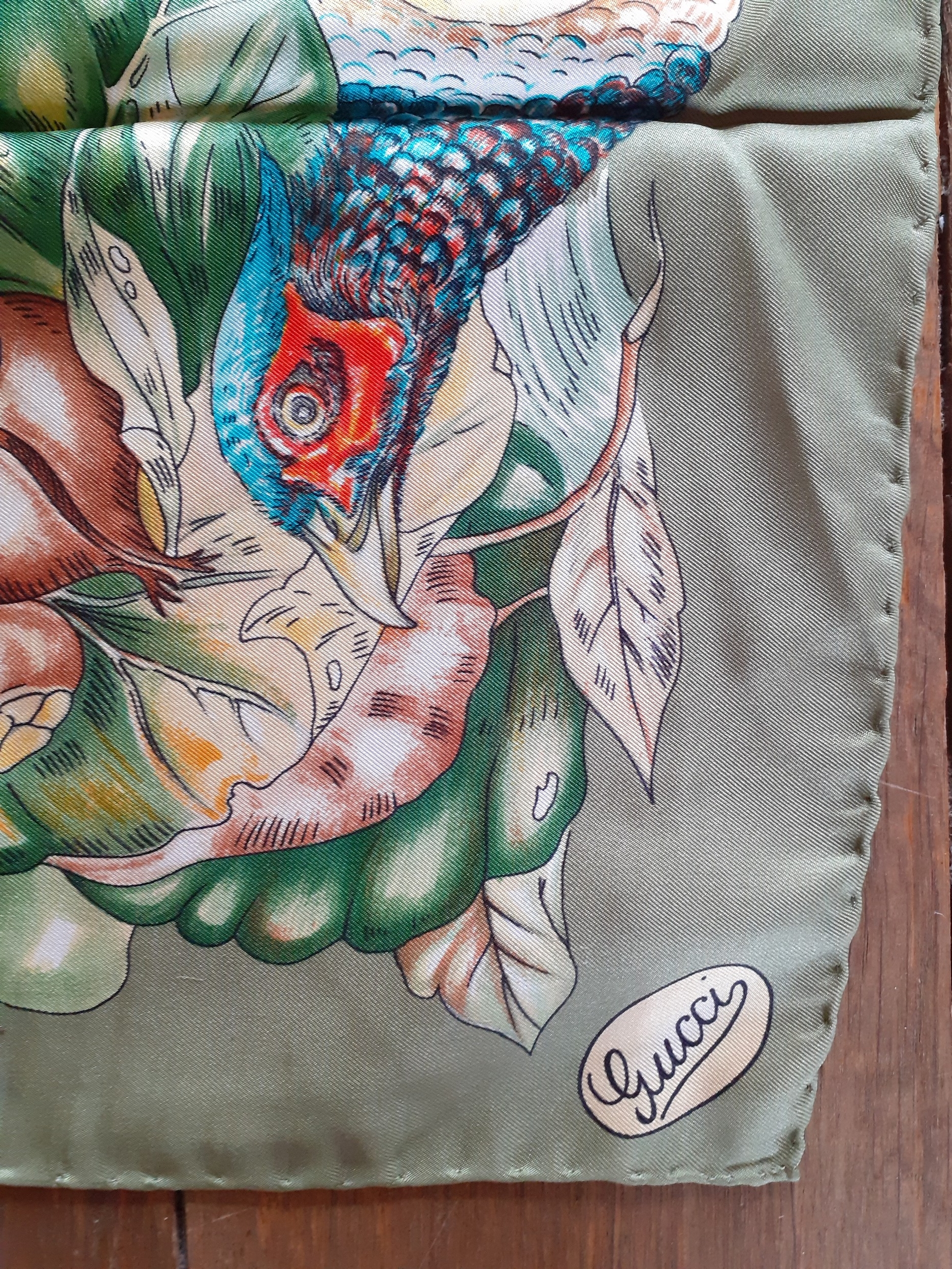 Gucci-A vintage Gucci silk scarf depicting images of a vegetable garden, game and insects on a green - Image 3 of 4