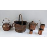 A selection of Victorian copper and brassware to include a graduating hanging cup measuring set,