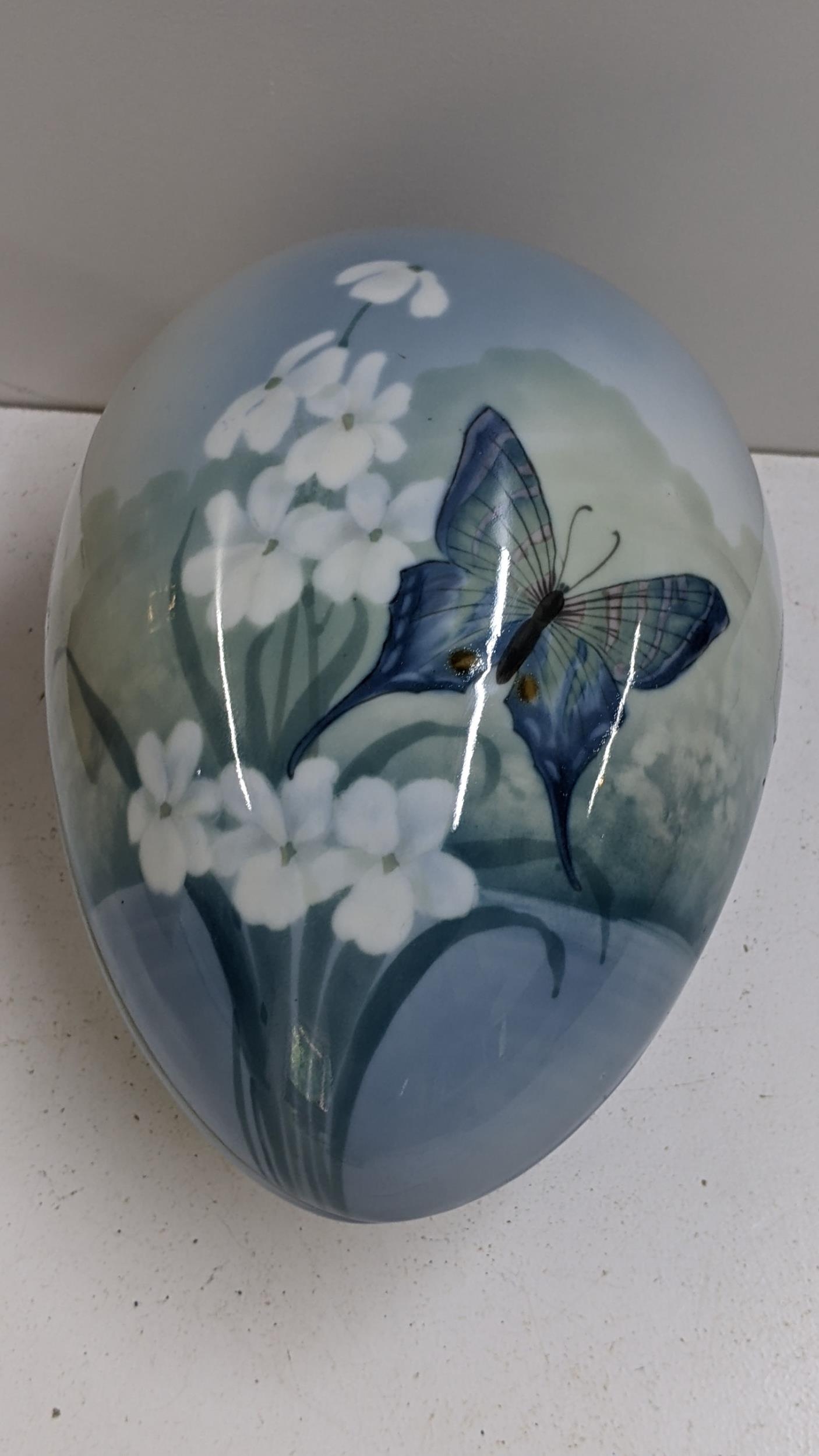 An early/mid 20th century Bernard Block porcelain egg in two sections and painted with a