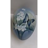 An early/mid 20th century Bernard Block porcelain egg in two sections and painted with a