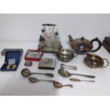 A mixed lot of silver plated items to include a three piece tea set, a six bottle cruet stand with