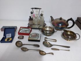 A mixed lot of silver plated items to include a three piece tea set, a six bottle cruet stand with